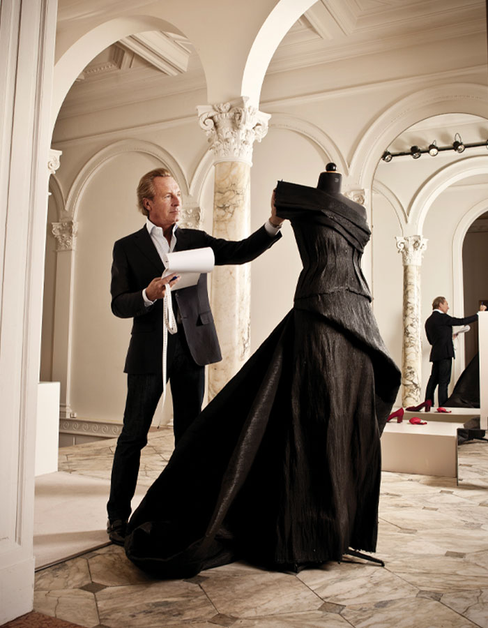 As heart-centered as talented, Belgian designer Edouard Vermeulen studies his beautiful fair trade evening dress woven by women in Africa for Princess Maxima’s 40th birthday